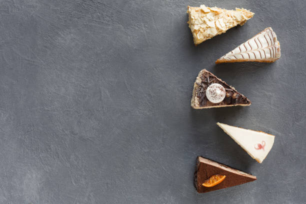 istock Assortment of pieces of cake, copy space 876931308