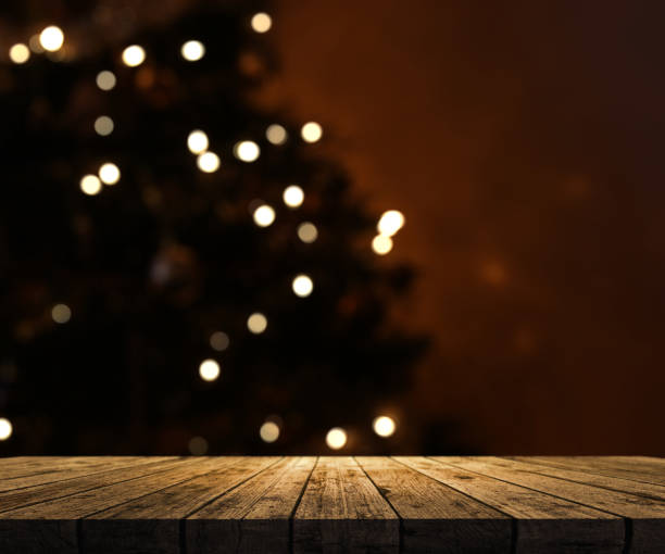 istock 3D wooden table looking out to a defocussed Christmas tree 876935044