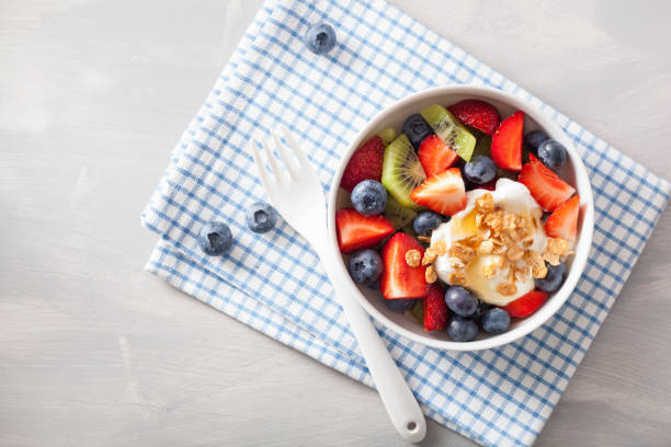 istock fruit berry salad with yogurt and granola for healthy breakfast 876935246