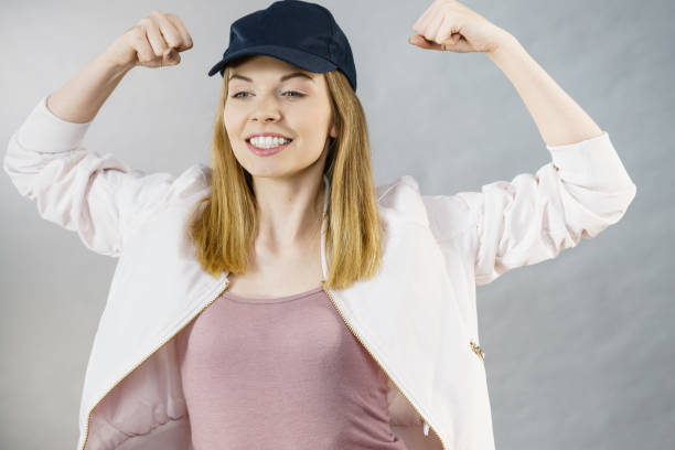 istock Young woman showing her arm muscles 876940870