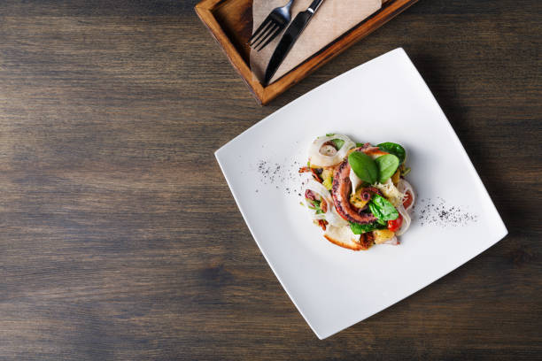 istock Salad with octopus and vegetables top view 876942044