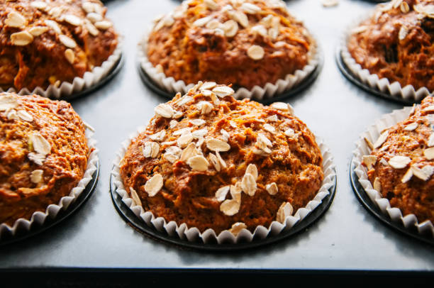 istock Healthy carrot cake muffins in a baking form. Close up 876945236