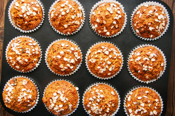 istock Healthy carrot cake muffins in a baking form. Top view. 876945252