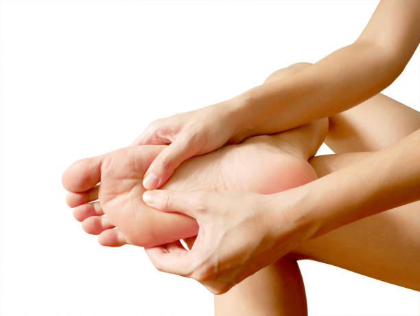 woman suffering from foot pain - reflexology human foot spa treatment health spa imagens e fotografias de stock