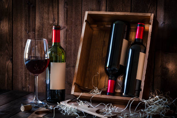 istock Wine bottles and wineglass shot rustic wooden table 876948096