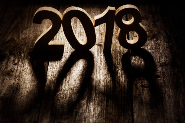 istock Happy New Year 2018 back lit wooden letters 876949186