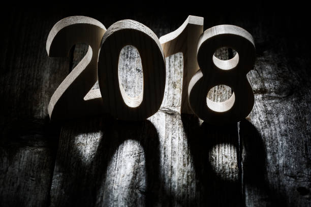 istock Happy New Year 2018 back lit wooden letters 876949228