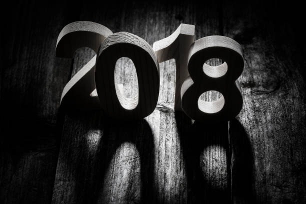 istock Happy New Year 2018 back lit wooden letters 876949280