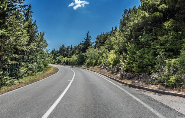 istock High-speed country road among the mountains 876949656