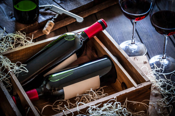 istock Wine bottles packed in a wooden box shot rustic wooden table 876953334