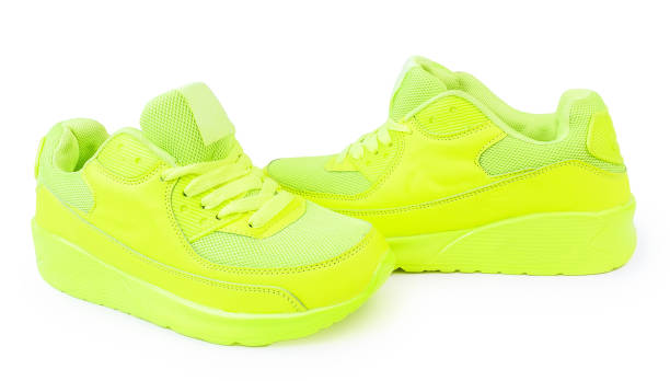 istock light green sneakers isolated white background. sports shoes isolate 876953394