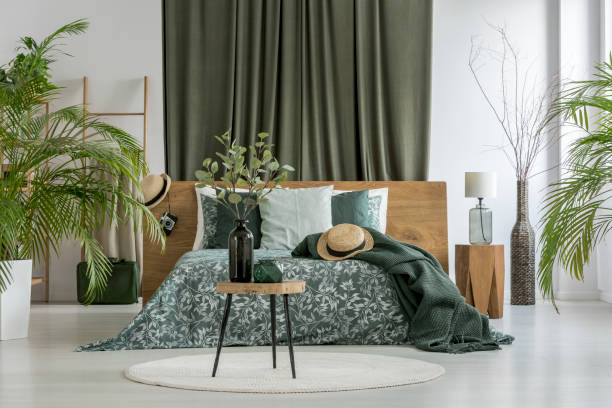 istock Green curtain behind king-size bed 876954012