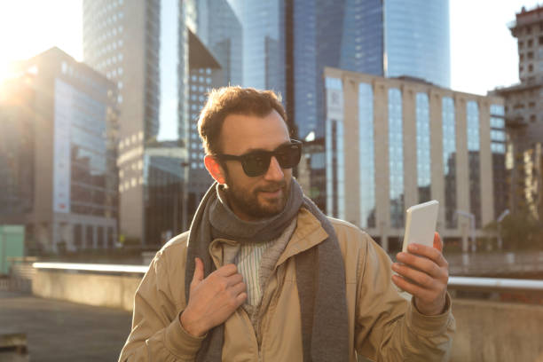 istock Modern guy using cellphone in the European city. 876954140