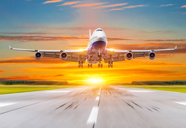 istock Passenger airplane landing at sunset on a runway. 876956906