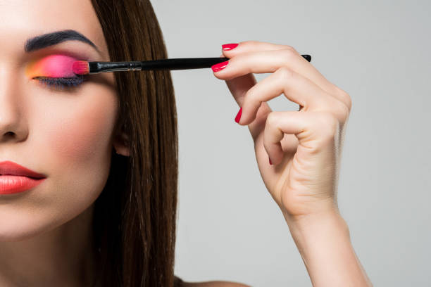 istock woman applying colorful eyeshadows 876956950