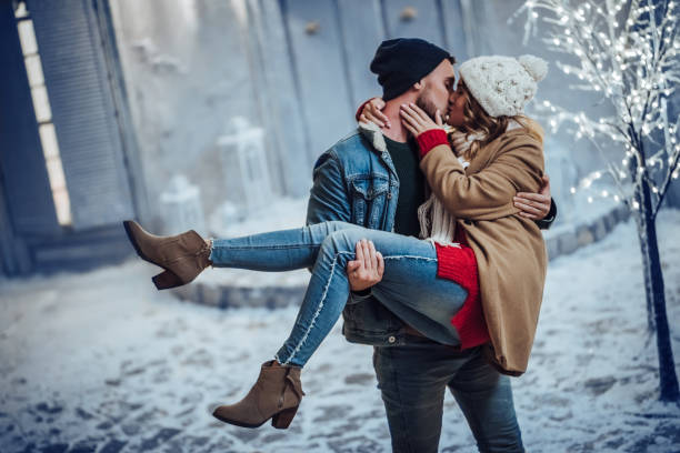 Young romantic couple is having fun outdoors in winter