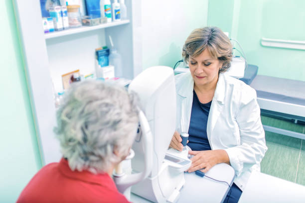 istock Optician with tonometer and patient at eye clinic 876958086