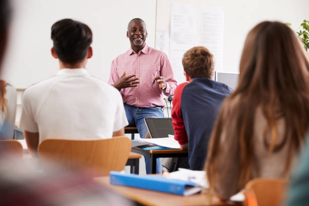 istock Teacher Standing At Front Of College Students For Lesson 876961816