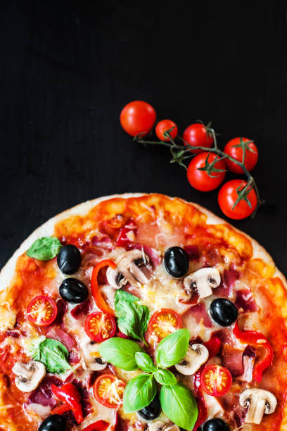 istock Hot pizza with Pepperoni Sausage on a dark background  with copy space. Cheese Pizza 