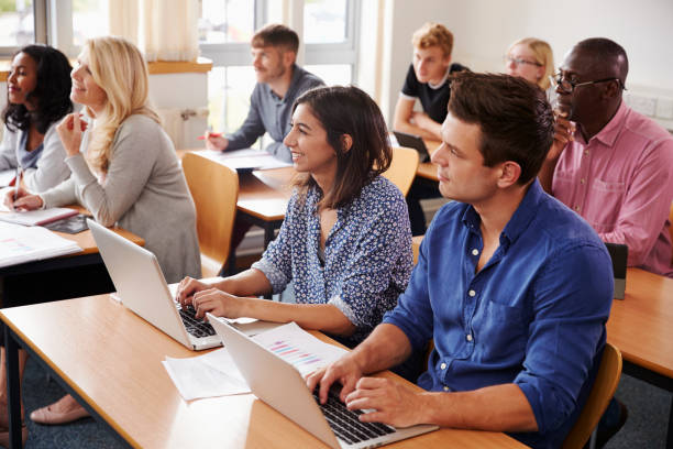 istock Mature Students Sitting At Desks In Adult Education Class 876965512