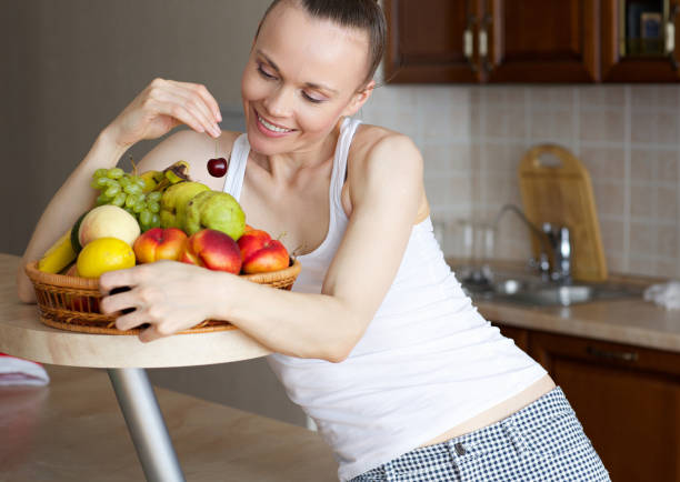 istock Young lady with fruits. 876965714