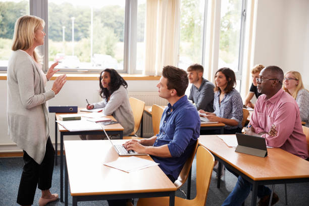 istock Female Tutor Teaching Class Of Mature Students 876965986