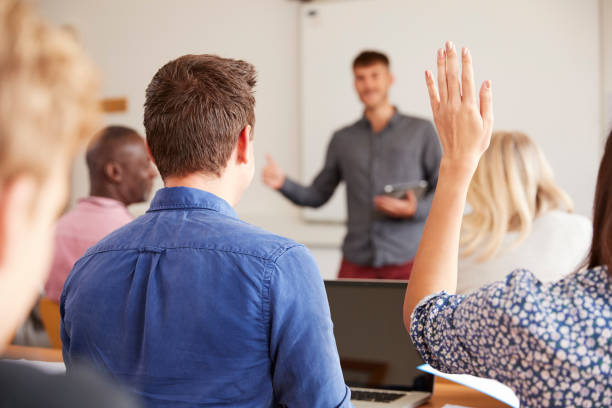 istock Rear View Of Mature College Student Asking Question In Class 876965990