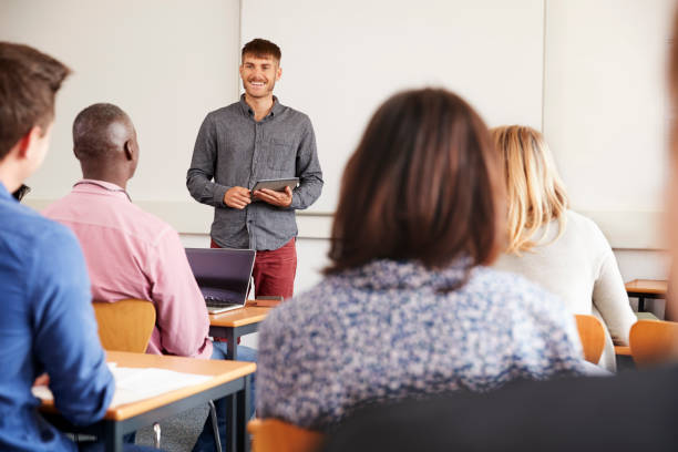 istock College Tutor With Digital Tablet Teaches Mature Students 876966428