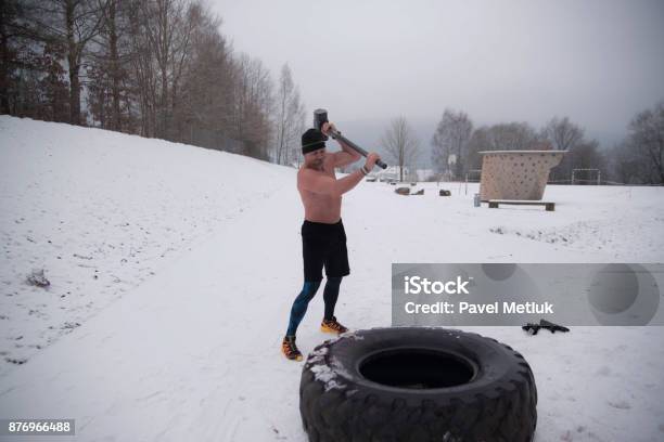 Sledgehammer Tire Hits Men Workout At Gym With Hammer And Tractor Tire Stock Photo - Download Image Now