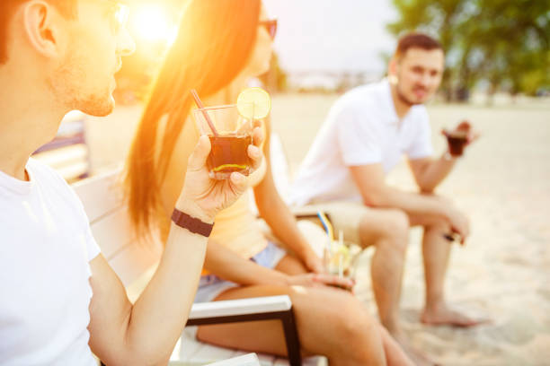 istock Young people enjoying summer vacation sunbathing drinking at beach bar 876969388
