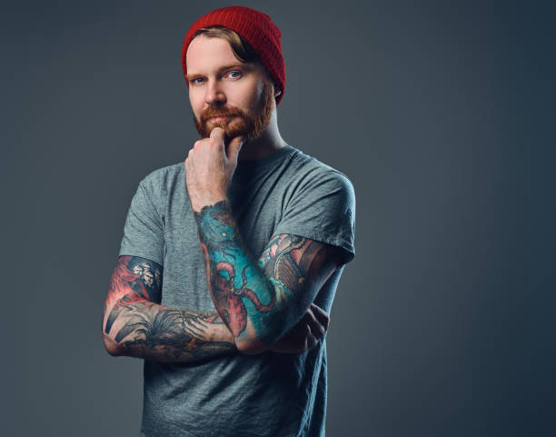 istock Tattooed bearded male over grey background. 876970242