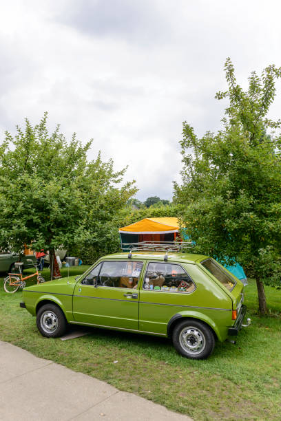 volkswagen golf mark i hatchback car with a caravan - golf bag imagens e fotografias de stock