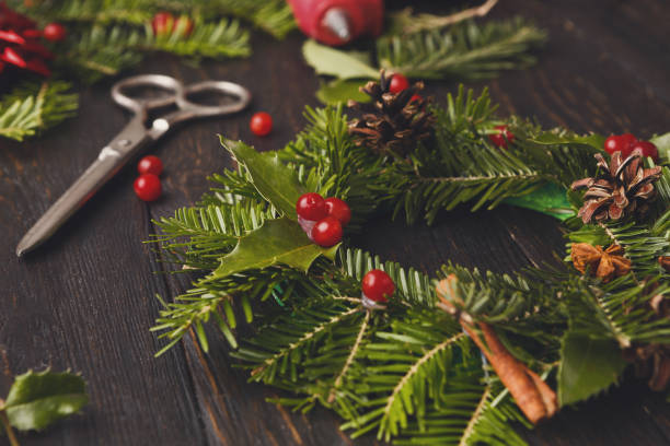 istock Handmde christmas wreath decoration on rustic wood background, vertical 876971764