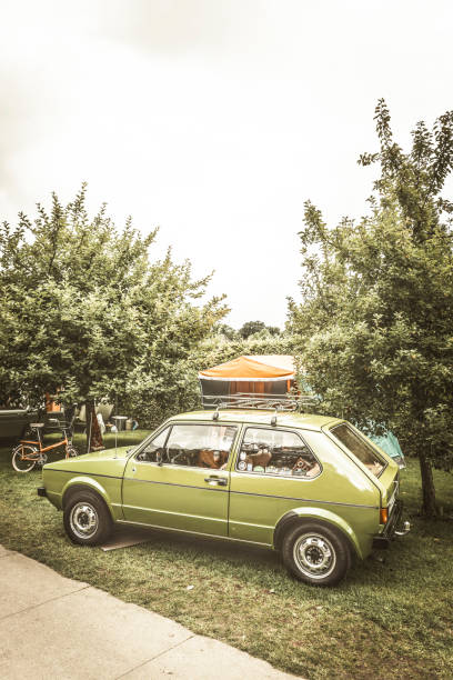 volkswagen golf mark i hatchback car with a caravan - golf bag imagens e fotografias de stock