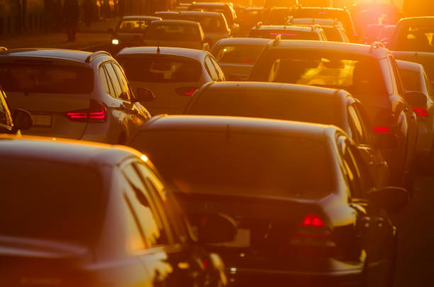 istock Cars are in traffic jam during a beautiful golden sunset 876974792