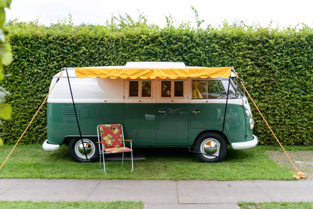 1950s Volkswagen Type 2 (T1) Transporter  Kombi or Microbus campervan with a sunblind parked in a park. The Volkswagen Transporter is a popular van to use as a camper and was delivered originally as a camper van, but many have been converted later. The car is on display during the 2017 Classic Days at Schloss Dyk in Juchen, Germany.