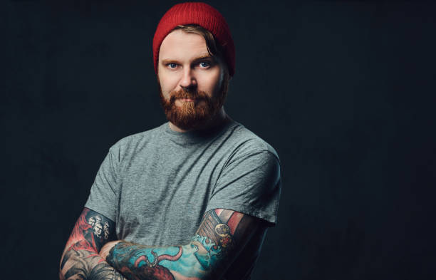 istock Tattooed bearded male over grey background. 876975384