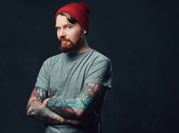istock Tattooed bearded male over grey background. 876975512