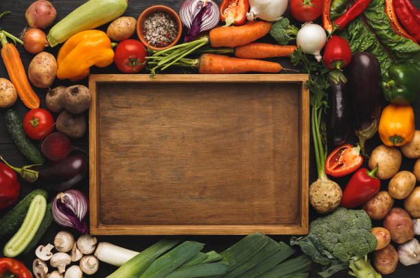 istock Fresh organic vegetables and wooden board background 876978194