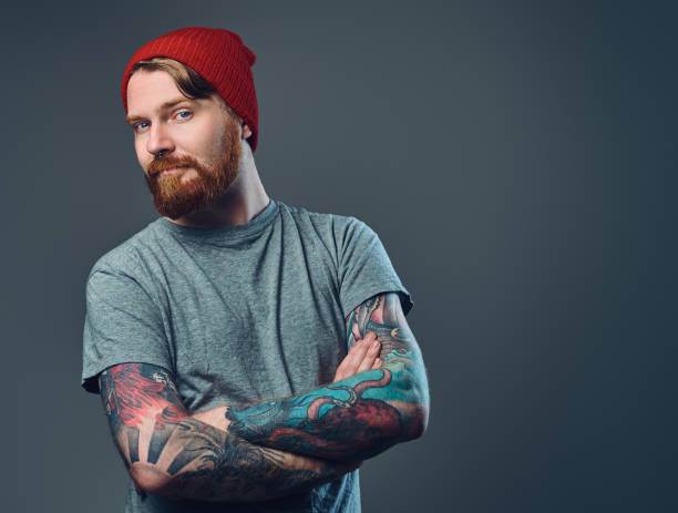 istock Tattooed bearded male over grey background. 876978276
