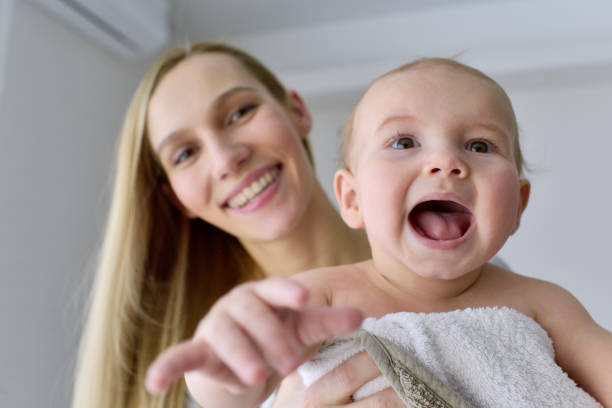 istock Mom holding excited baby 876979490
