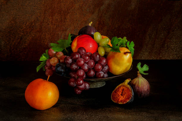 istock Still life with fruits: grape, apple, fig, pear on the antique copper tin plate 876986592