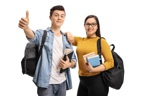 istock Cheerful teenage students with backpack and books making a thumb up sign 876991576