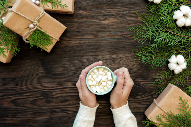 istock female hand holding cup of chocolate with marshmallow 876994180