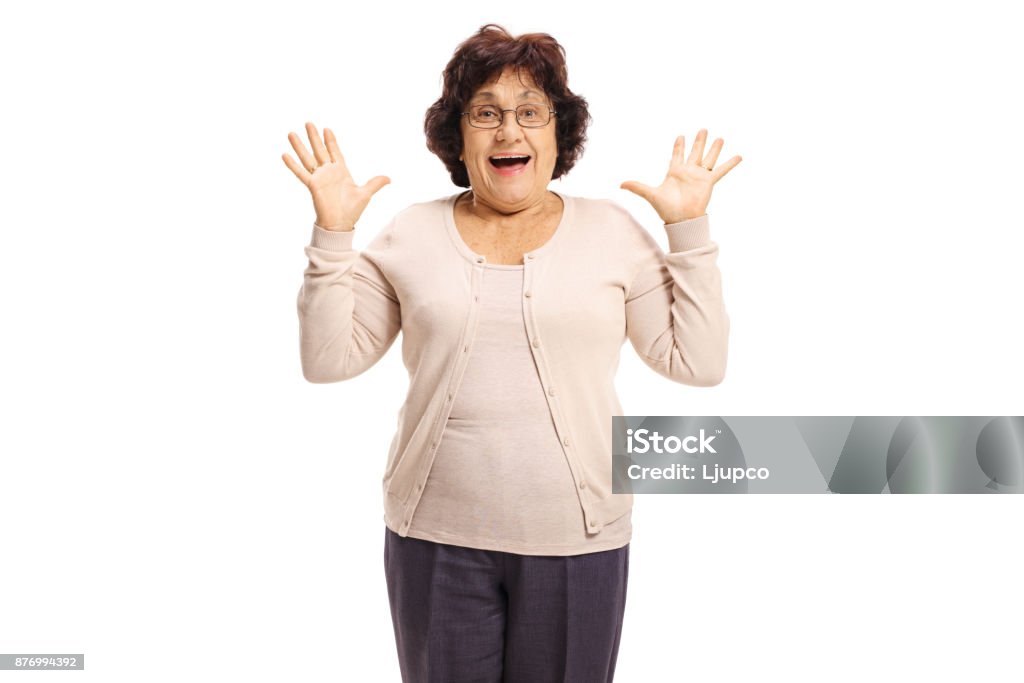 Surprised senior lady gesturing with her hands Surprised senior lady gesturing with her hands isolated on white background Surprise Stock Photo