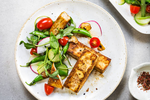 istock Tofu steak with Snow Peas and Rocket Salad 876995126