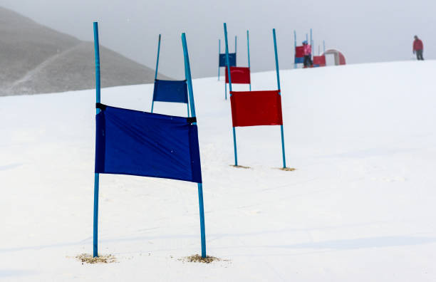 children skiing slalom racing track with blue and red gates. - skiing sports race ski mountain range imagens e fotografias de stock