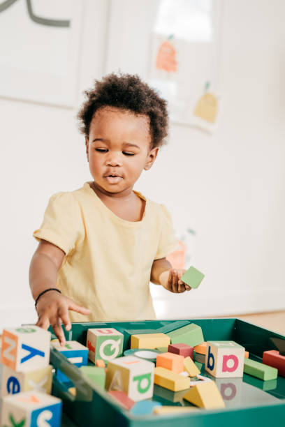 istock Toddler with wooden blocks 876998014