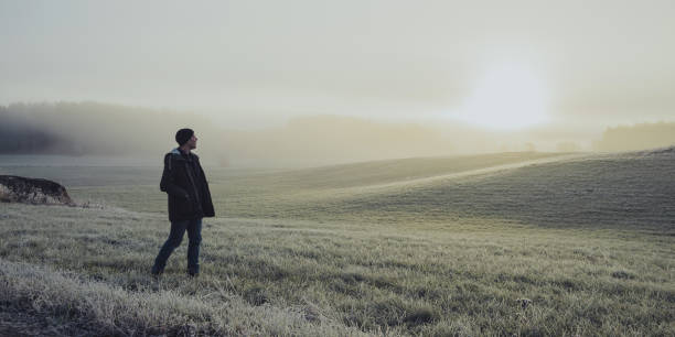 istock Man out with his car in winter nature landscape 876998810