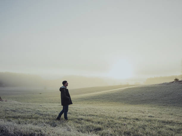 istock Man out with his car in winter nature landscape 876998812